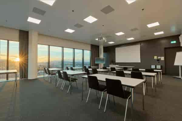 Modern conference room with sunset view, perfect for meetings and workshops.
