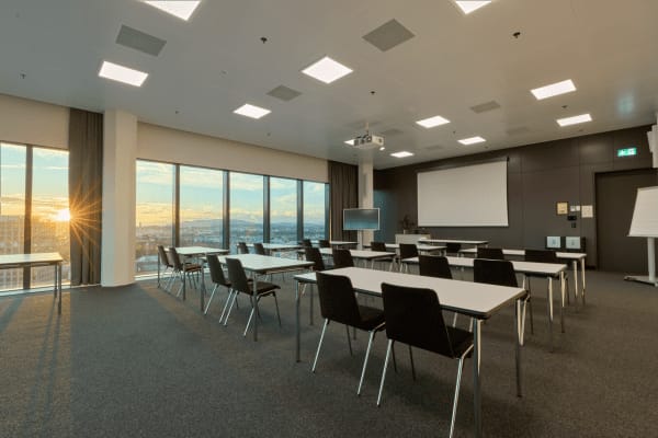 Modern conference room with sunset view, perfect for meetings and workshops.