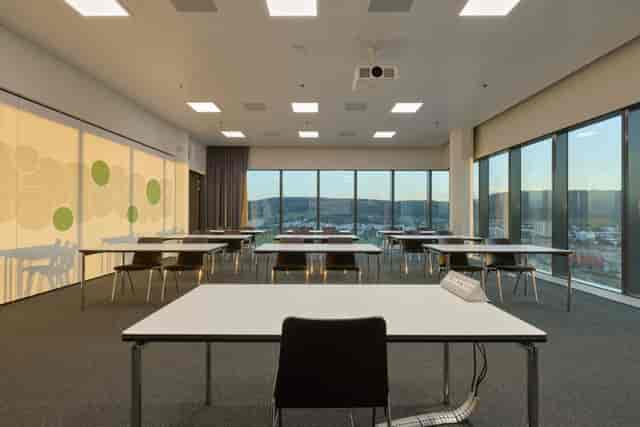 Modern function room with spacious tables for corporate meetings and workshops.
