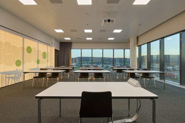 Modern function room with spacious tables for corporate meetings and workshops.