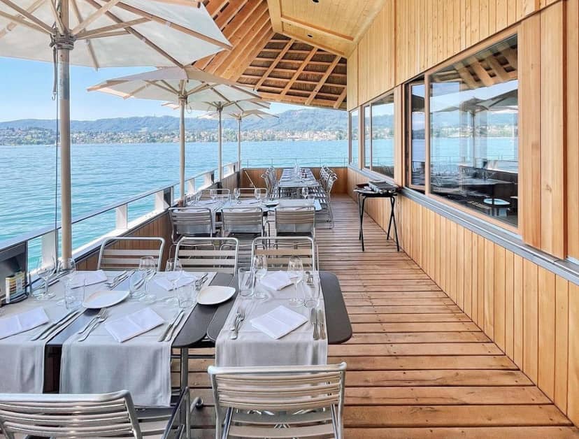 Elegant lakeside restaurant with outdoor dining, perfect for corporate events and networking.