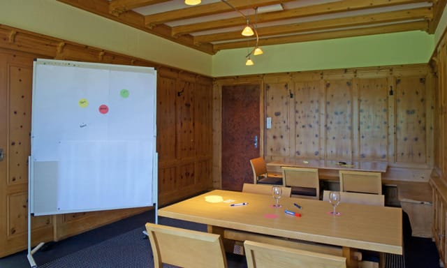 Cozy Felsenegg Seminar Room with wood elements, ideal for workshops and meetings.