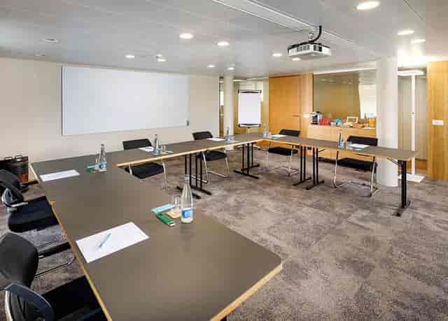 Modern Felsenegg Seminar Room with u-shaped table for productive meetings.