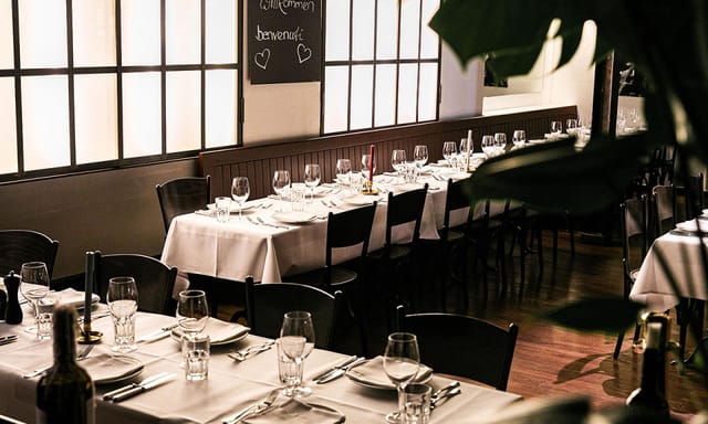Elegant restaurant dining space with natural light for corporate events and gatherings.