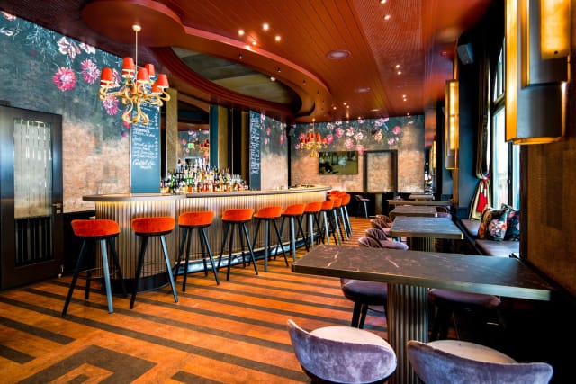 Stylish bar area with floral decor, perfect for networking events in Carlton.