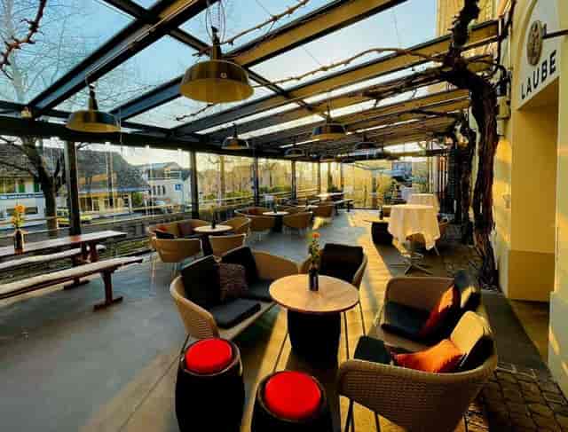 Stylish outdoor pergola venue with glass roof, perfect for events and gatherings.