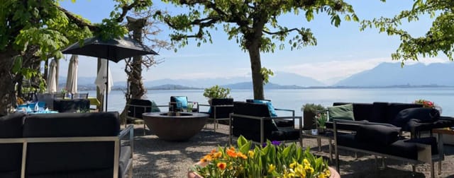 Outdoor meeting space by water with vibrant flowers, perfect for team-building retreats.