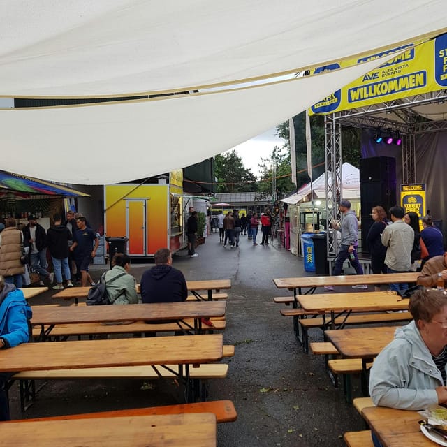 Horse riding school event in Zürich-Dielsdorf with festive outdoor seating and food stalls.