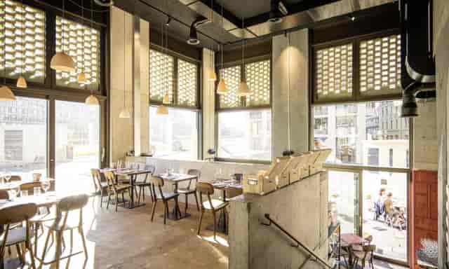 Modern restaurant with natural light, wooden decor—ideal for events in Zurich.