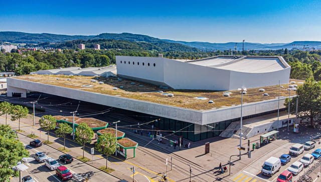 Modern auditorium with eco-friendly design at St. Jakobshalle Basel for conferences and events.