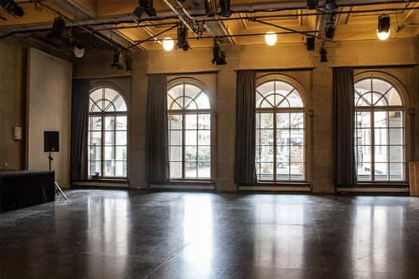 Kalkbreitesaal event venue with large arched windows for workshops and networking.