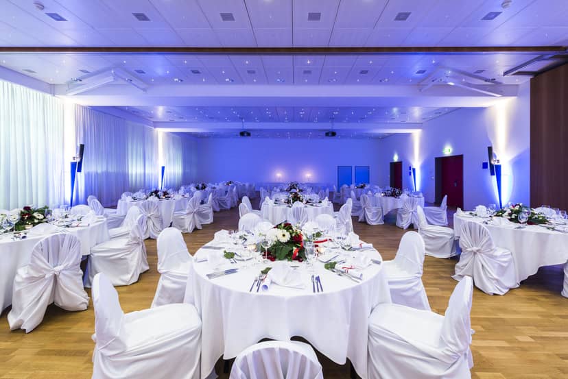 Elegant Gigerstübli event space with floral centerpieces, perfect for weddings and corporate dinners.