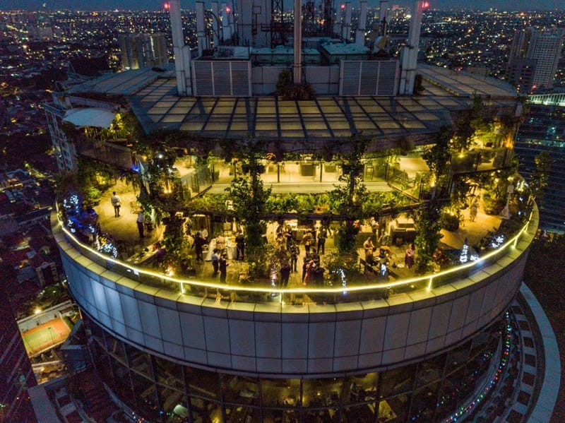 Rooftop ballroom venue with greenery and skyline, ideal for upscale events and gatherings.