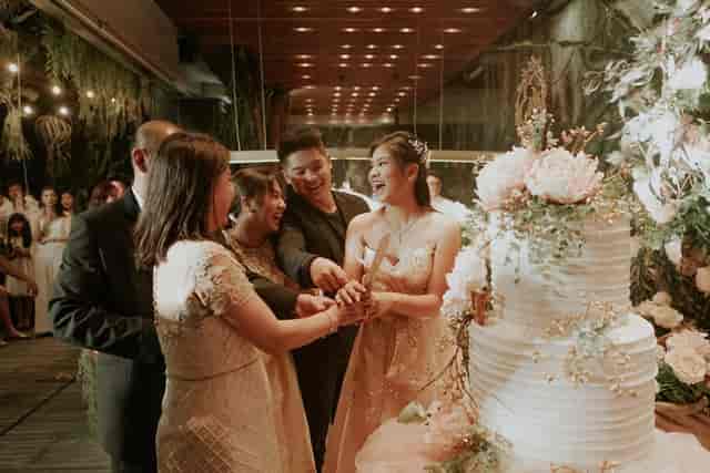 Wedding celebration in The Imperium ballroom with a decorated cake and elegant ambiance.