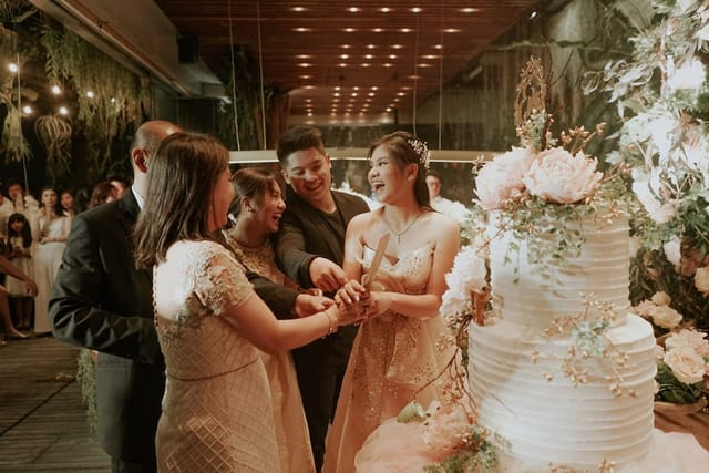 Wedding celebration in The Imperium ballroom with a decorated cake and elegant ambiance.