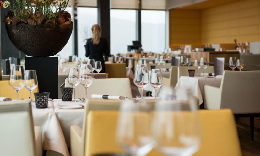 Elegant function room at CLOUDS Kitchen with polished glassware for upscale events.