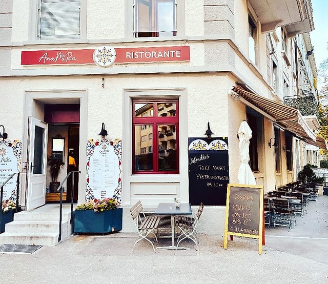 Charming restaurant entrance with outdoor seating, perfect for casual gatherings and events.