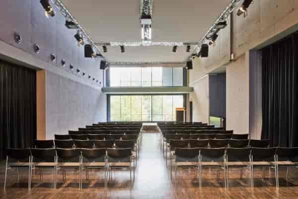 Modern event space in Trafo Baden with rows of chairs for corporate workshops.