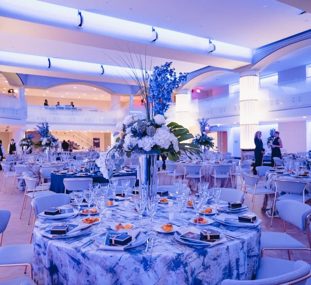 Elegant Hamilton Ballroom event space with floral centerpieces, perfect for networking and celebrations.