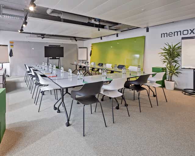 Modern meeting room at memox Europaallee with long table, ideal for collaboration events.