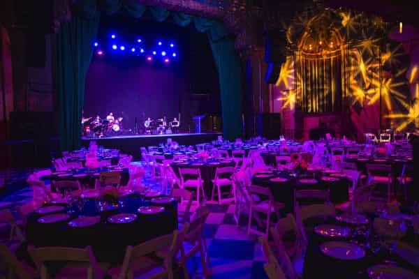 Elegant dinner setup at The Jayne Bar, Fonda Theatre, with vibrant stage lighting.