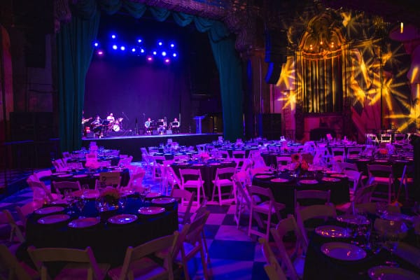 Elegant dinner setup at The Jayne Bar, Fonda Theatre, with vibrant stage lighting.