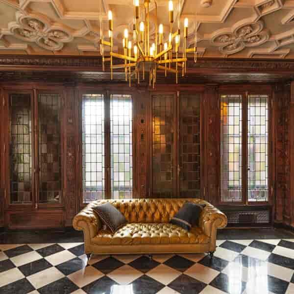 Luxurious English Room in The Blackstone with vintage stained glass for intimate events.