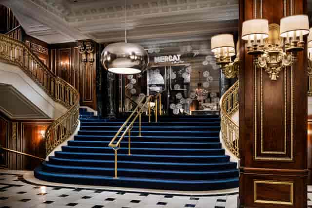 Elegant entrance with grand staircase, ideal for luxury events and networking.