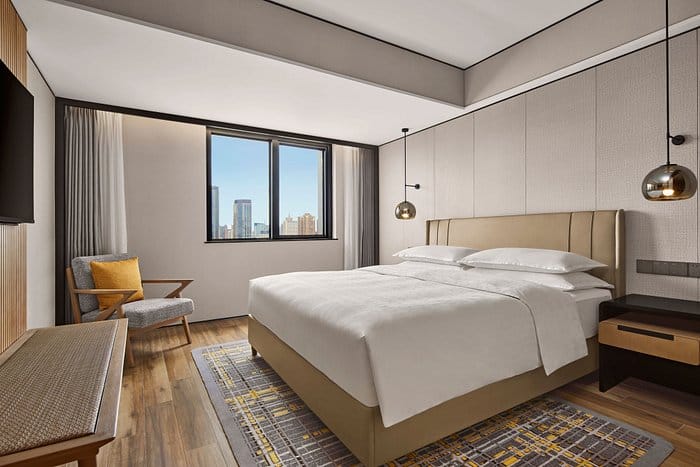 Modern hotel suite with city views, ideal for business events and gatherings.