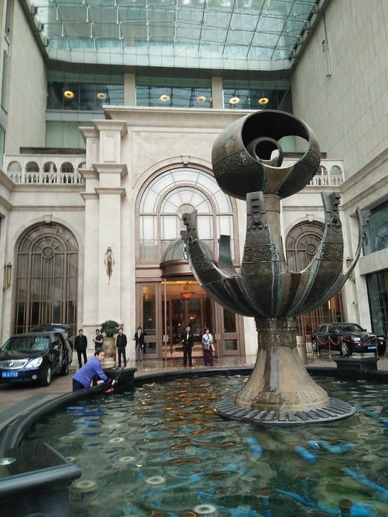 Elegant hotel entrance with decorative fountain at RenHe Spring Hotel for upscale events.