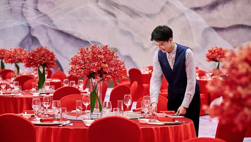 Yixin Grand Ballroom setup with red tables for a formal event at Hotel Nikko Chengdu.