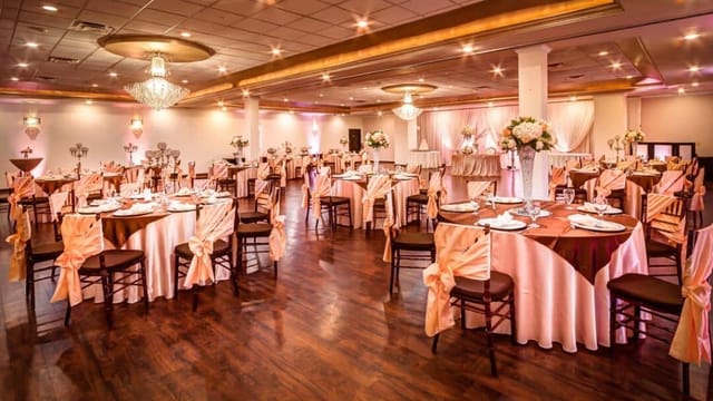 Elegant banquet hall with soft pink decor, ideal for weddings and corporate events.