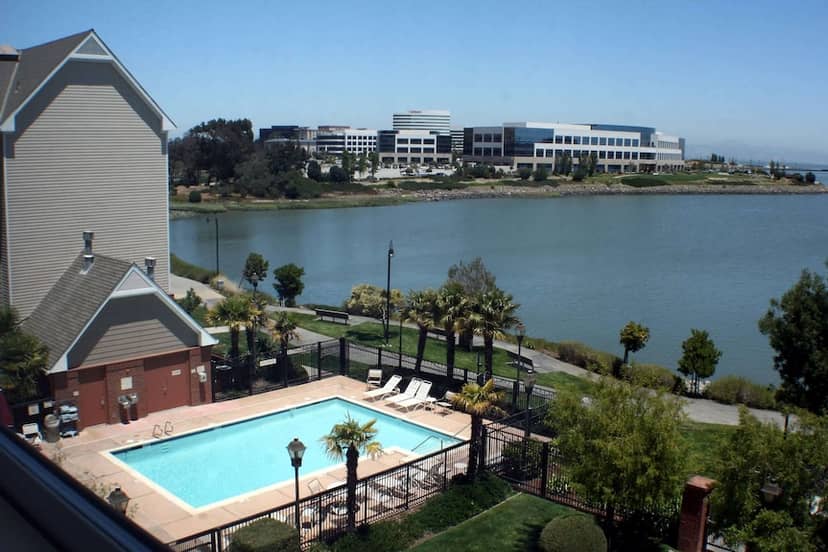 Tranquil lakeside retreat at AC Hotel with pool, ideal for corporate events and meetings.