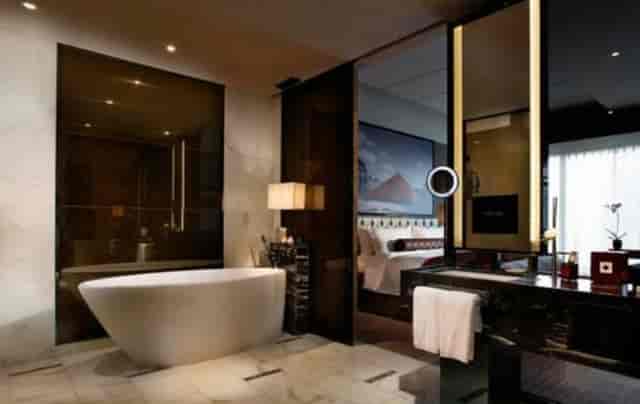 Luxurious hotel bathroom with freestanding tub for corporate retreats at Sofitel Guangzhou.