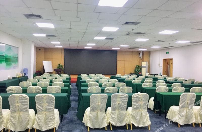 Conference Hall at Shanshui Trends Hotel with green tables, ideal for conferences and workshops.