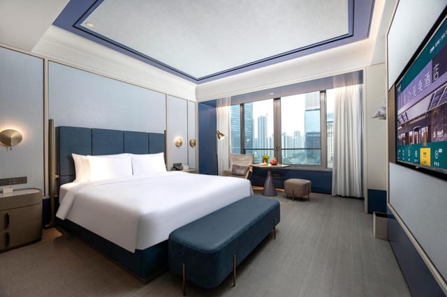 Grand Ballroom in Maxx Guangzhou: modern hotel room with king-sized bed, ideal for events.