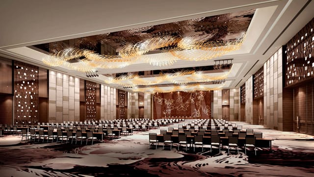 Grand Ballroom at Pullman Guangzhou: elegant venue for conferences with stunning chandeliers.