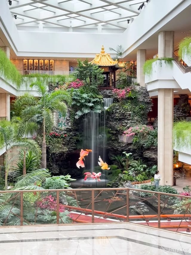 Serene back garden with waterfall at White Swan Hotel, perfect for eco-friendly events.