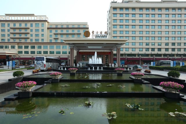 Dong Fang Hotel convention center exterior with water feature, ideal for events and conferences.