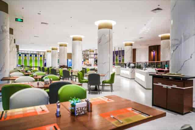 VIP Dining Room at Dong Fang Hotel with green chairs, ideal for elegant events and gatherings.