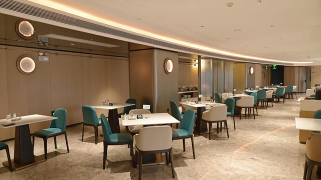 Sophisticated restaurant in Ocean Hotel with teal chairs, ideal for corporate events.