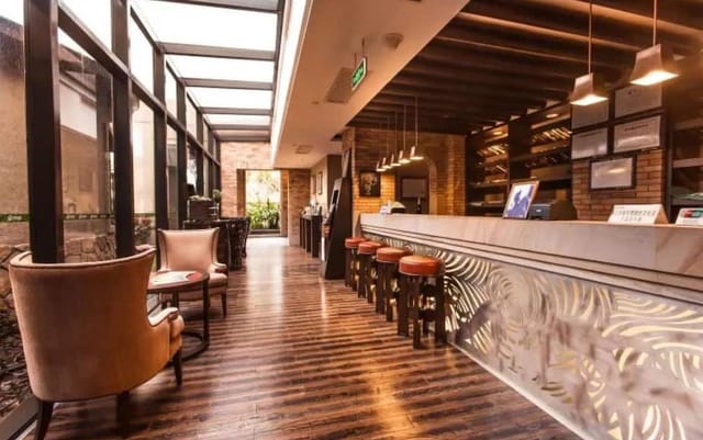 Modern conference room at Chime Long Hotel with stylish bar, ideal for networking events.