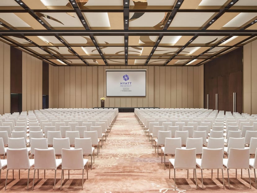 Meeting Room 9 at Zeng Cheng Hotel, spacious conference setup with white chairs.