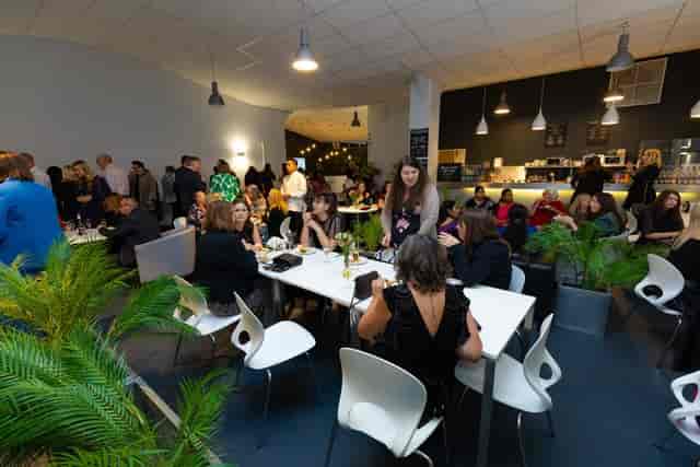 Riverside Cafe: Modern event space with greenery for social gatherings and corporate events.