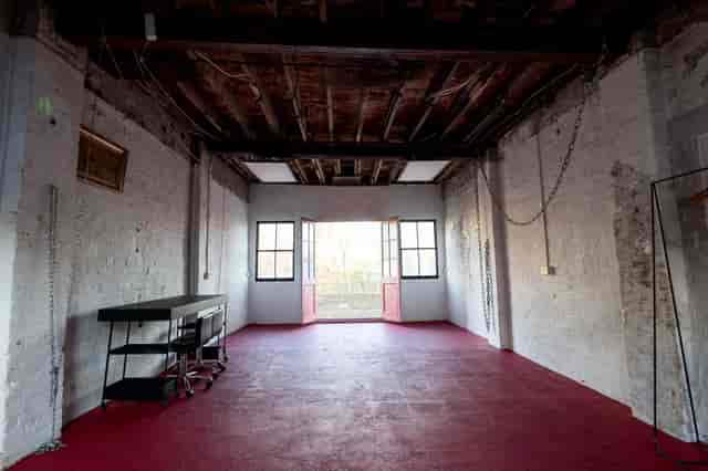 Victorian industrial event space with exposed brick and natural light, ideal for gatherings.