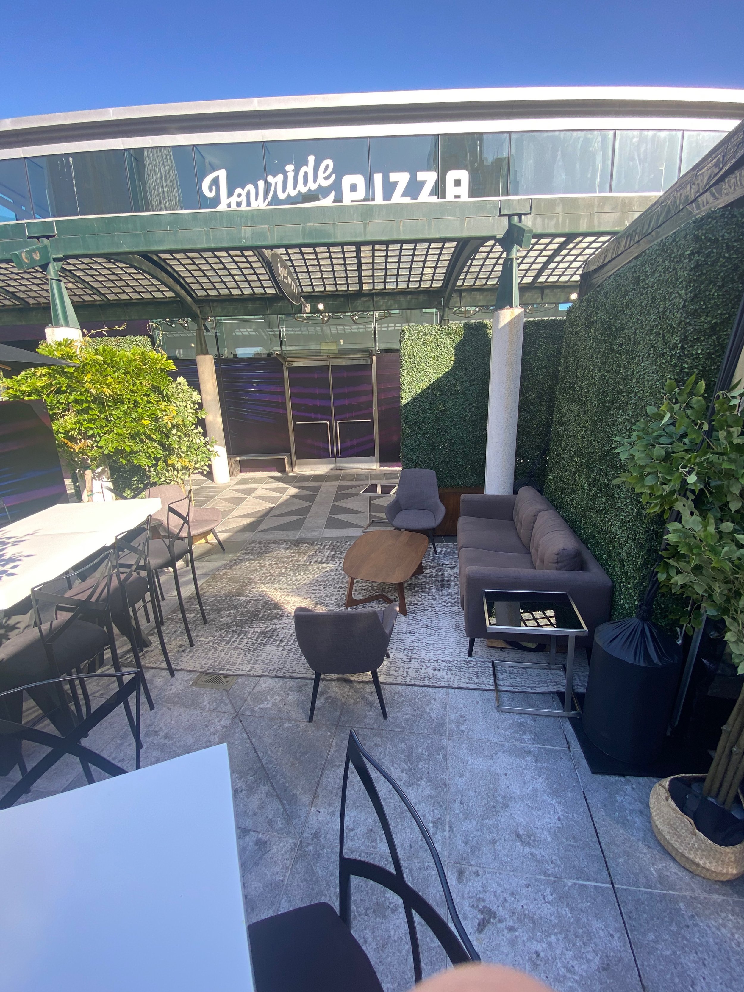 Stylish outdoor lounge at Joyride Pizza for networking events and informal meetings.