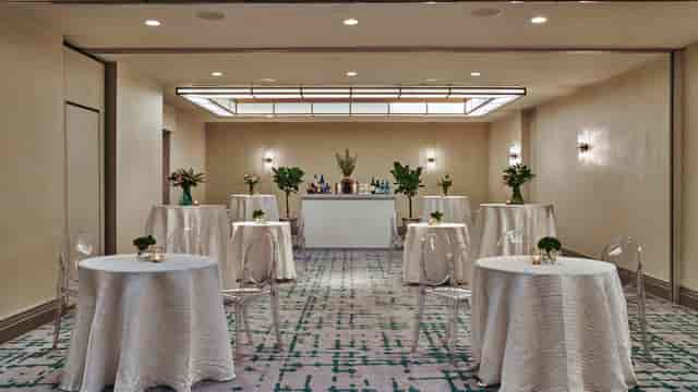 Elegant event space at Viceroy DC with round tables, ideal for networking and receptions.