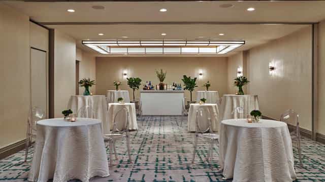 Elegant event space at Viceroy DC with round tables, ideal for networking and receptions.