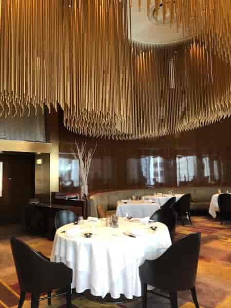 Elegant banquet hall with wooden ceiling, perfect for upscale meetings and private dinners.