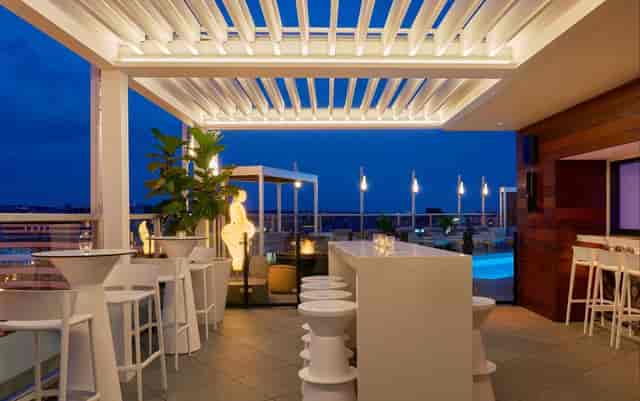 Modern rooftop lounge at Hotel Zena, perfect for cocktail receptions and networking events.